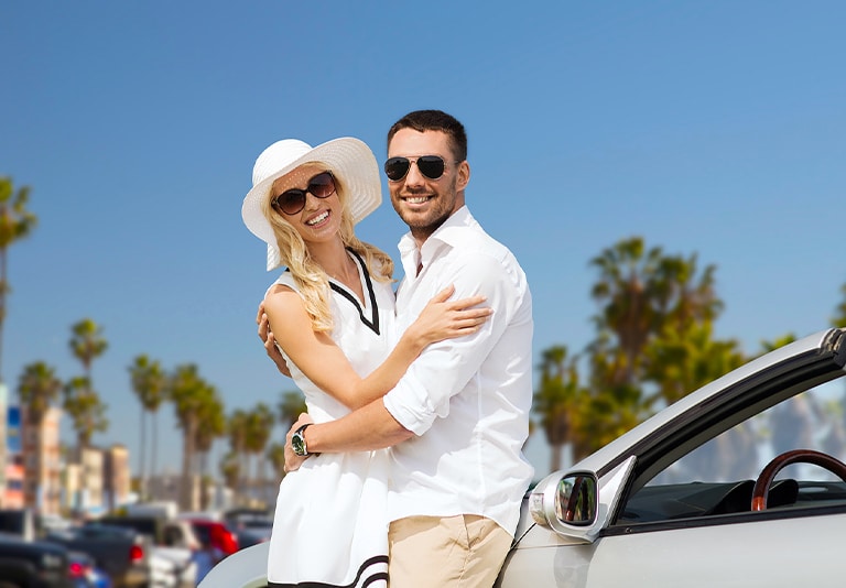Happy couple enjoying a luxury rental from Step One Car Rental in Fort Walton Beach, FL