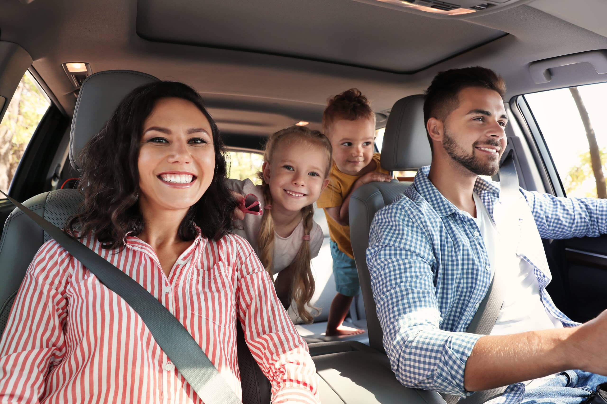 Happy family enjoying a spacious SUV rental from Step One Car Rental in Fort Walton Beach, FL.