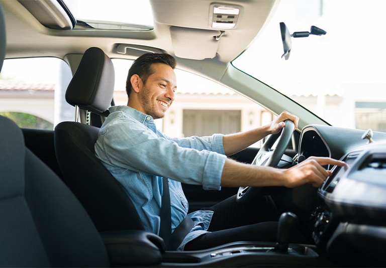 Happy customer in one of Step One Car Rental's dependable car rentals in Fort Walton Beach, FL
