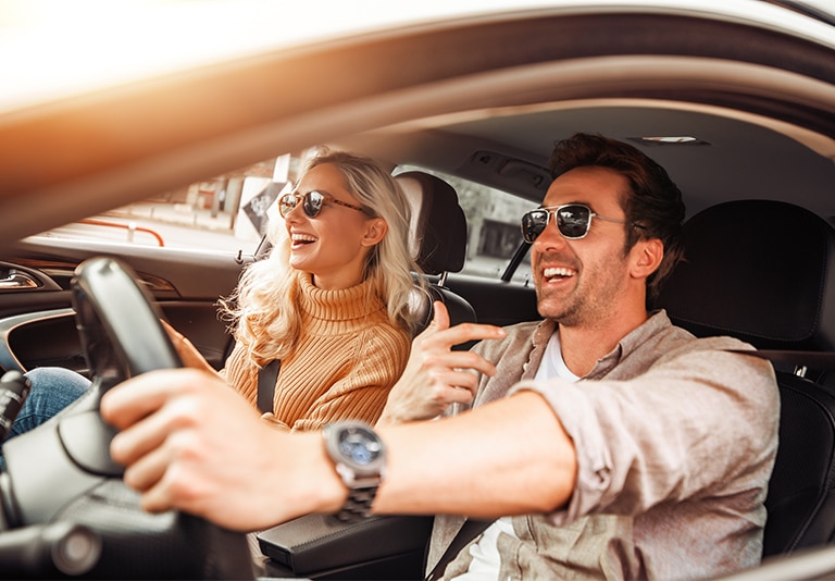 Happy couple enjoying a car rental from Step One Car Rental in Fort Walton Beach, FL.
