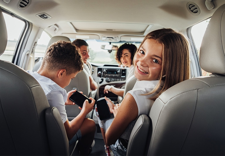 Family enjoying a comfortable and spacious minivan rental from Step One Car Rental in Fort Walton Beach, FL